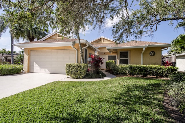 single story home with a garage and a front lawn