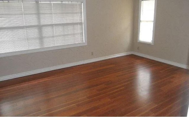 empty room with dark hardwood / wood-style floors