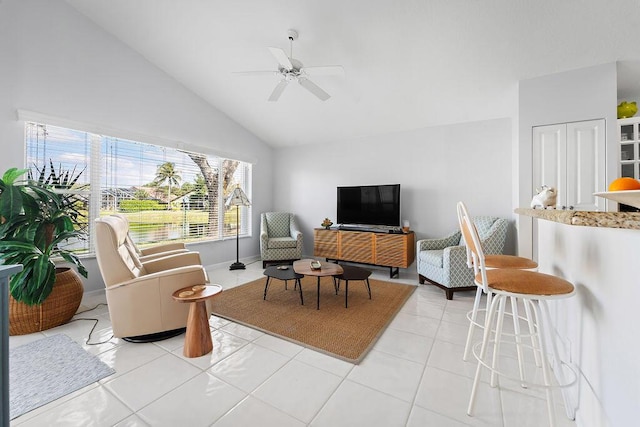 tiled living room featuring vaulted ceiling and ceiling fan