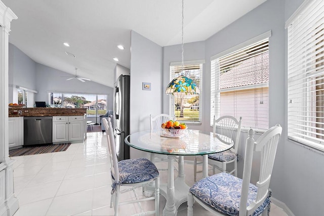 dining area featuring ceiling fan, vaulted ceiling, and light tile patterned floors