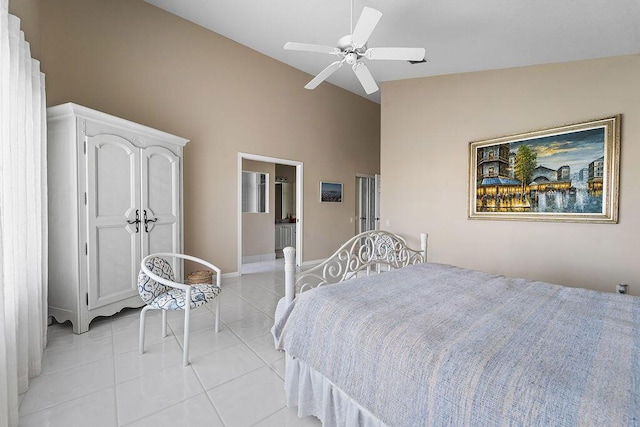 tiled bedroom featuring high vaulted ceiling, ceiling fan, and ensuite bathroom