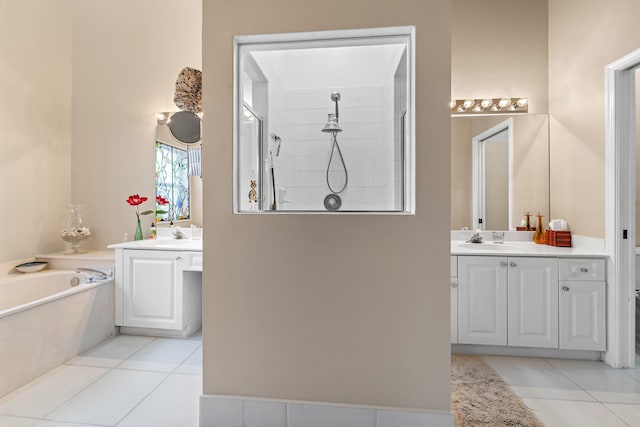 bathroom featuring independent shower and bath, vanity, and tile patterned floors