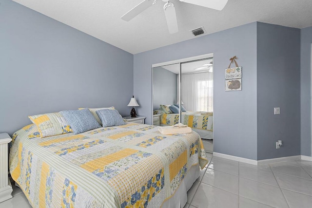 tiled bedroom featuring a closet and ceiling fan