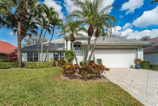 single story home with a garage and a front yard