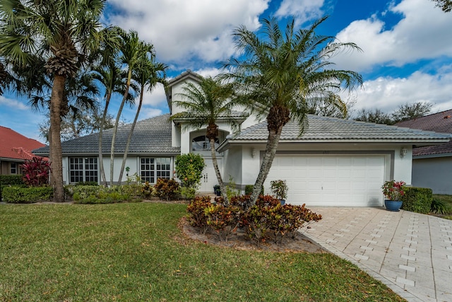 view of front of house with a garage and a front lawn