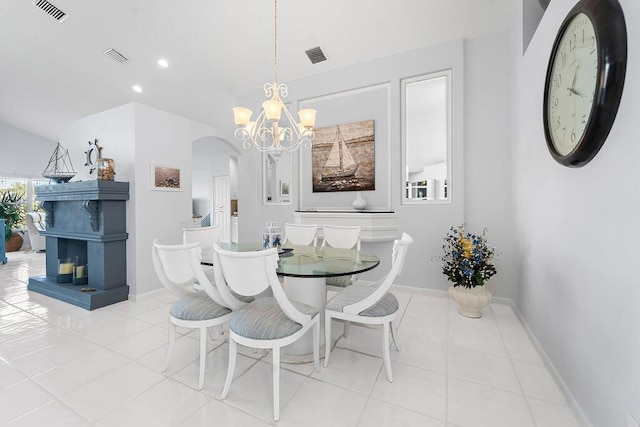 dining room with a chandelier and light tile patterned flooring