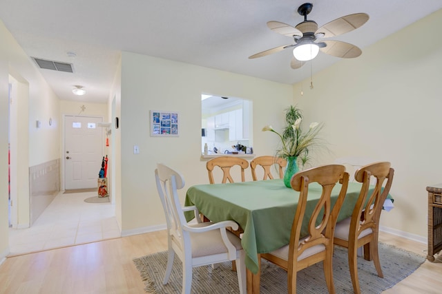 dining space featuring light hardwood / wood-style flooring and ceiling fan