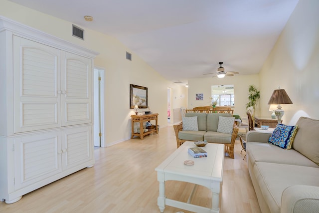 living room featuring vaulted ceiling, ceiling fan, and light hardwood / wood-style flooring