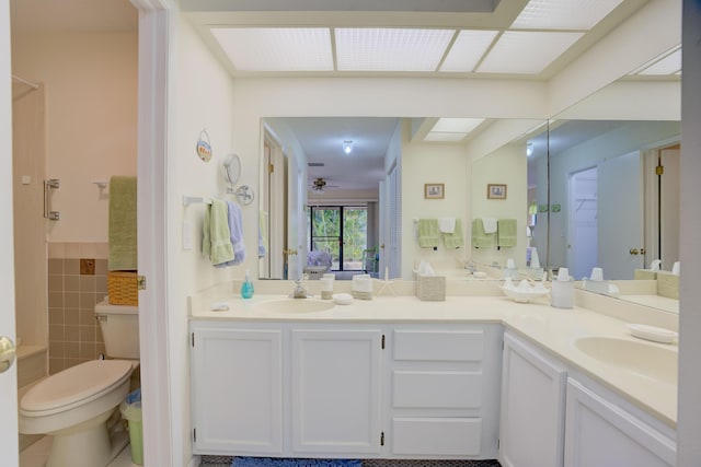 bathroom with tile walls, tile patterned flooring, vanity, ceiling fan, and toilet