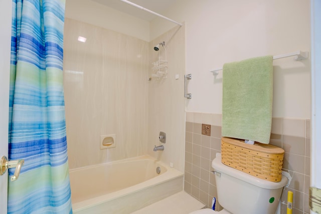 bathroom featuring tile walls, shower / tub combo, and toilet