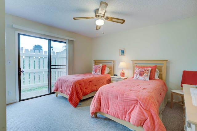 carpeted bedroom with ceiling fan, access to outside, and a textured ceiling