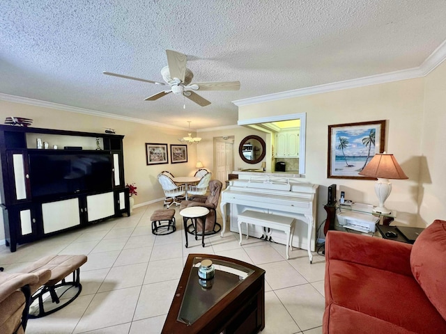 living room featuring light tile patterned flooring, ceiling fan, ornamental molding, and a textured ceiling