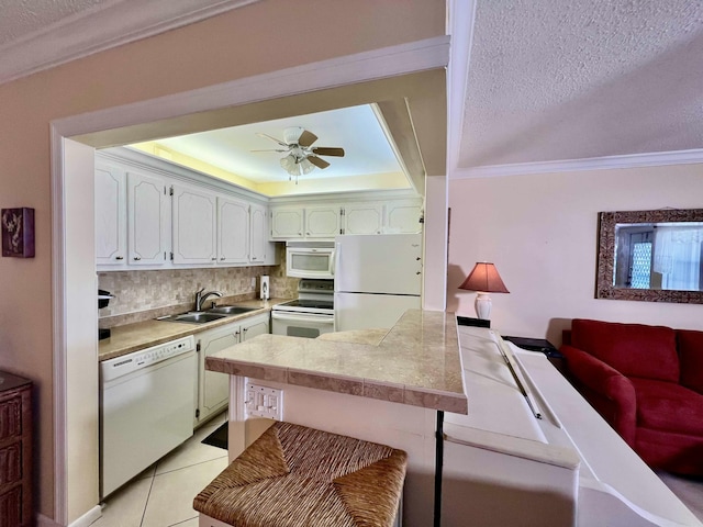 kitchen with white appliances, sink, a textured ceiling, and white cabinets