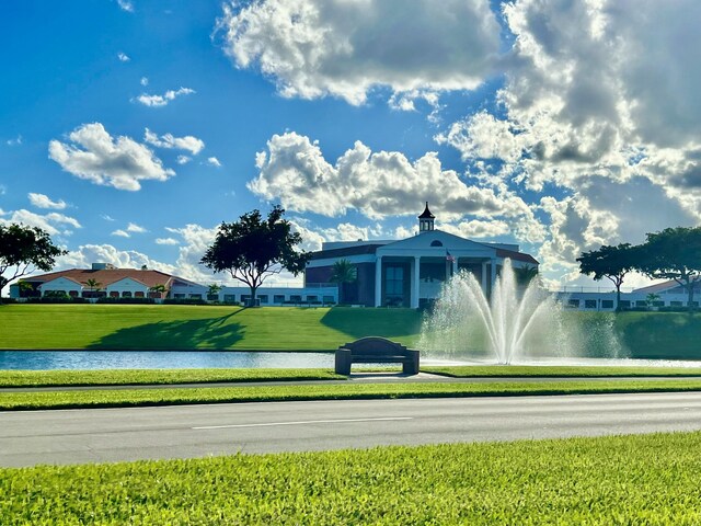 view of property's community featuring a water view and a yard