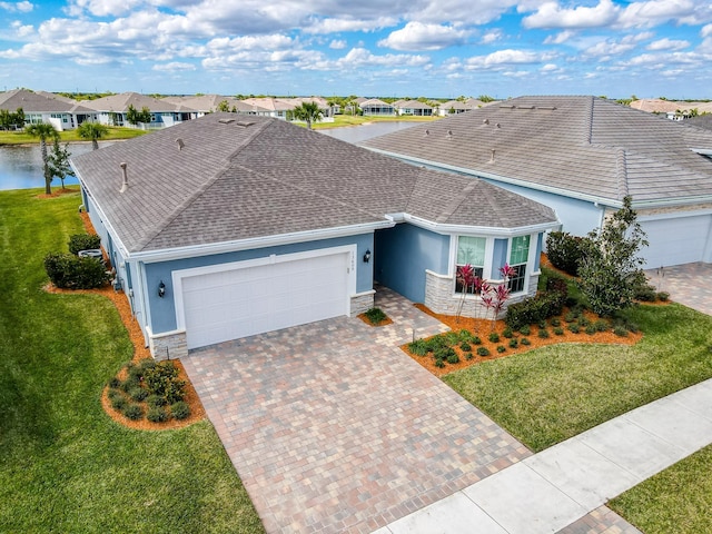 single story home with a garage and a front lawn