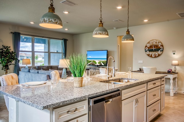 kitchen featuring sink, stainless steel dishwasher, white cabinets, and light stone counters