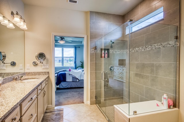 bathroom featuring tile patterned flooring, vanity, and walk in shower