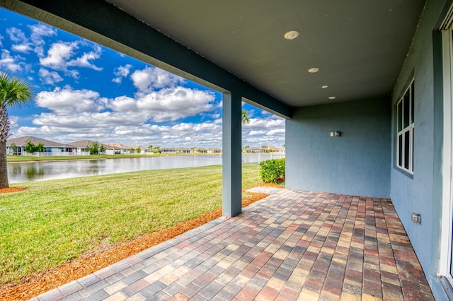 view of patio with a water view