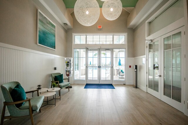 rec room with crown molding, pool table, light wood-type flooring, and a tray ceiling