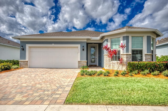 view of front of property with a garage and a front lawn