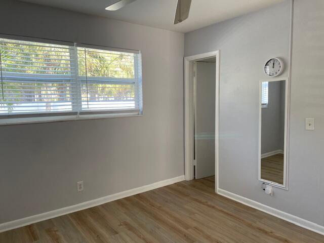 unfurnished bedroom with hardwood / wood-style flooring