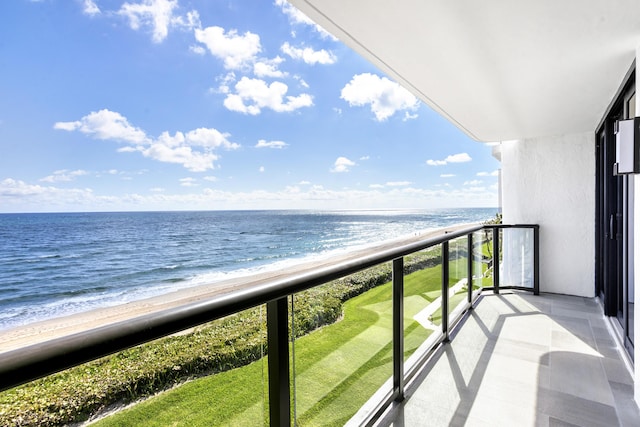 balcony featuring a water view and a view of the beach