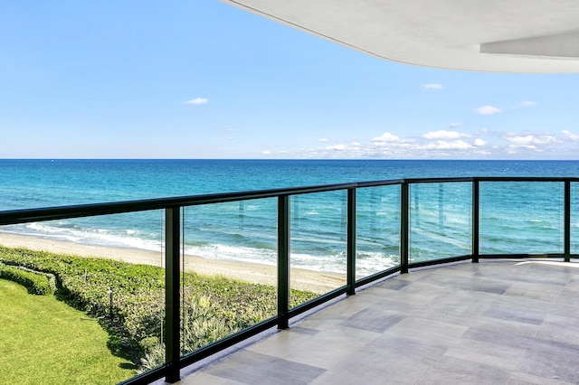 balcony featuring a water view and a view of the beach