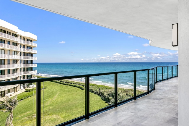 balcony featuring a water view and a view of the beach