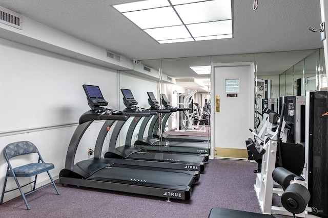 workout area featuring a textured ceiling