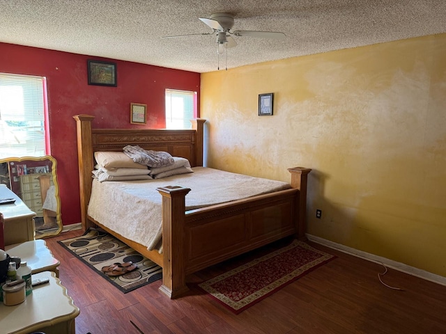 bedroom with a textured ceiling, wood-type flooring, and ceiling fan