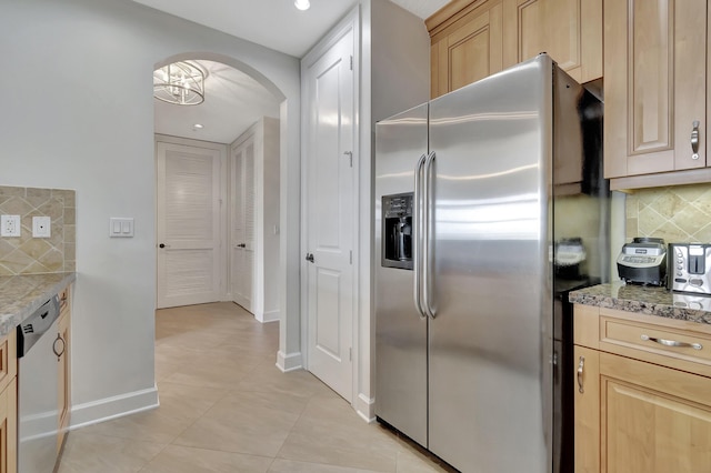 kitchen with stainless steel appliances, light brown cabinets, and light stone counters