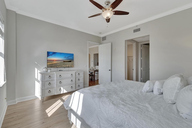 bedroom with ornamental molding, ceiling fan, and light wood-type flooring