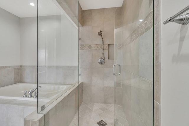 bathroom with shower with separate bathtub