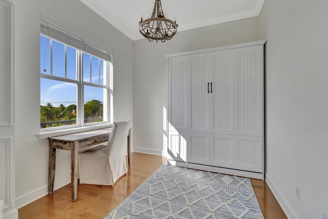 entryway with an inviting chandelier, crown molding, and wood-type flooring