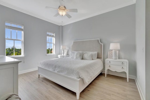 bedroom with crown molding, light hardwood / wood-style flooring, and ceiling fan