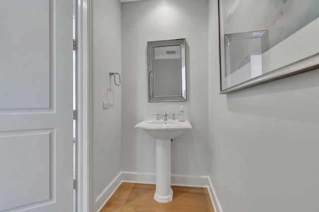 bathroom with hardwood / wood-style flooring