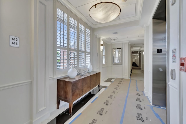 entryway featuring ornamental molding and elevator