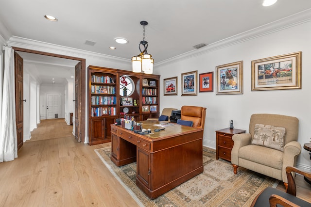 office area with crown molding and light hardwood / wood-style flooring