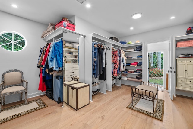 spacious closet with light hardwood / wood-style flooring