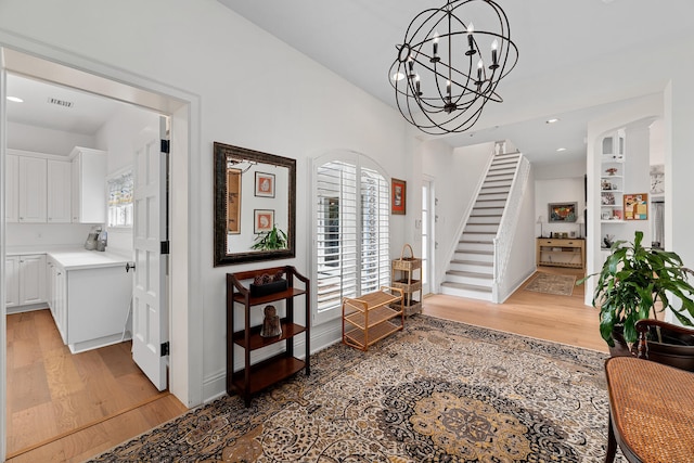 entrance foyer with hardwood / wood-style flooring and a chandelier