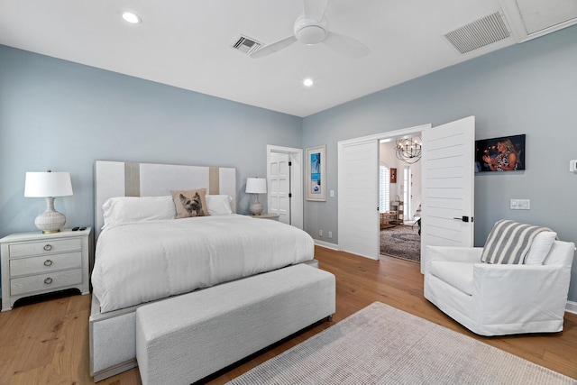 bedroom with light hardwood / wood-style floors and ceiling fan