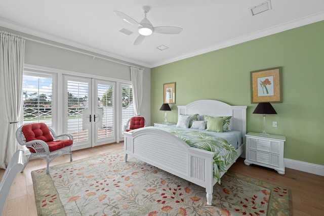 bedroom featuring crown molding, ceiling fan, wood-type flooring, access to outside, and french doors