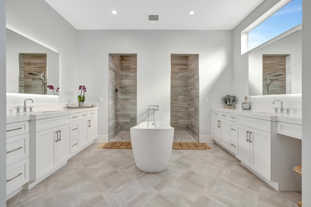 bathroom featuring vanity and plus walk in shower