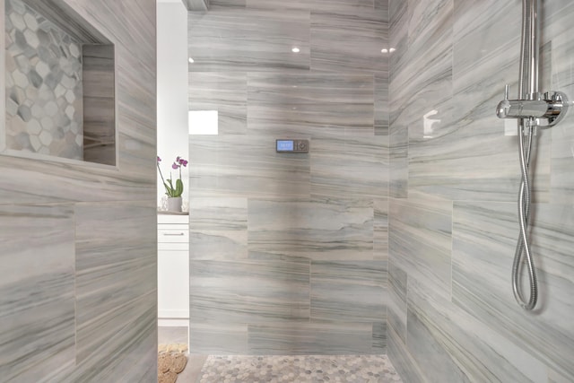 bathroom with a tile shower