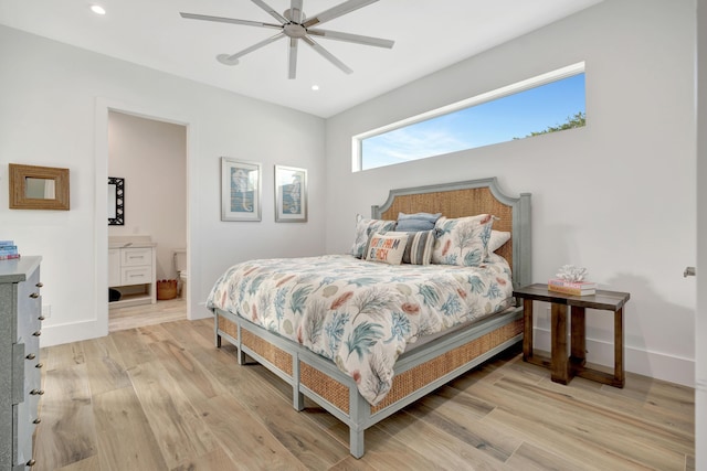 bedroom featuring ceiling fan, light wood-type flooring, and ensuite bath