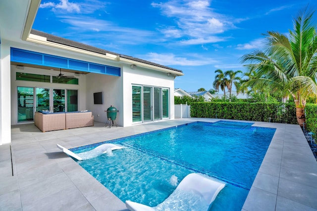 view of pool featuring pool water feature, ceiling fan, an outdoor hangout area, and a patio area