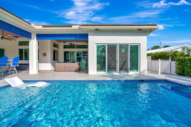 view of pool with ceiling fan and a patio