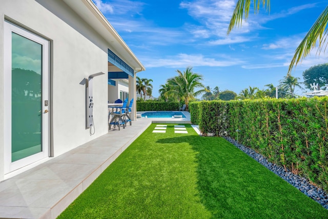 view of yard featuring a fenced in pool and a patio