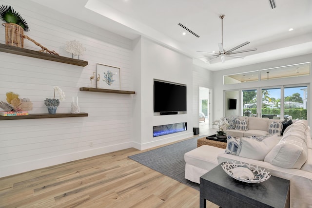 living room with hardwood / wood-style flooring and ceiling fan