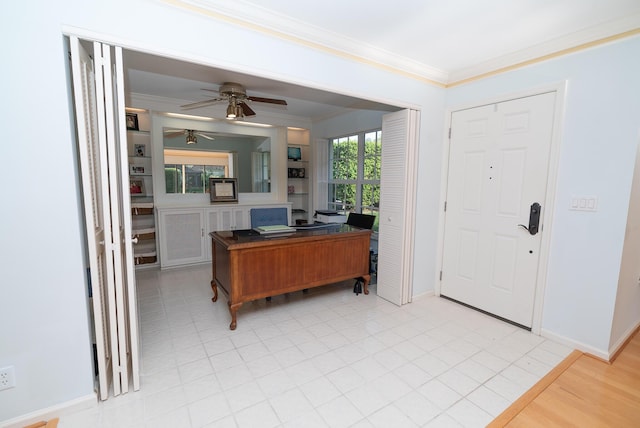 home office with crown molding and ceiling fan